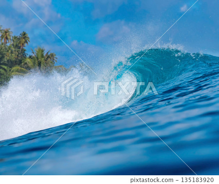 Blue wave breaking on a beach in sea Blue wave breaking on a beach in sea 135183920