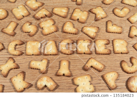 Cracker cookies in the shape of the letters on a wooden surface 135184023