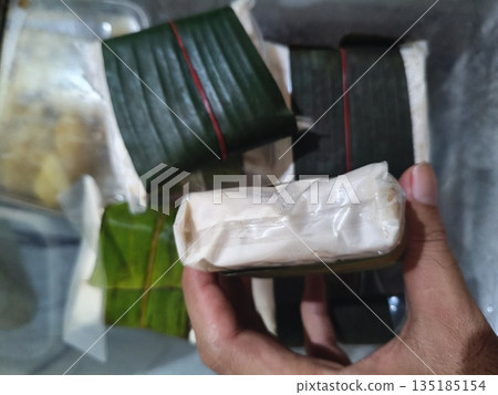 tempeh wrapped in plastic and banana leaves 135185154