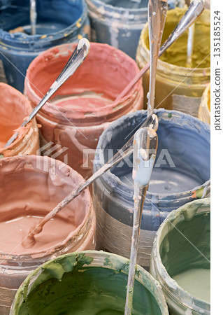 Group of open cans of multi-coloured paints Group of open cans of multi-coloured paints 135185524