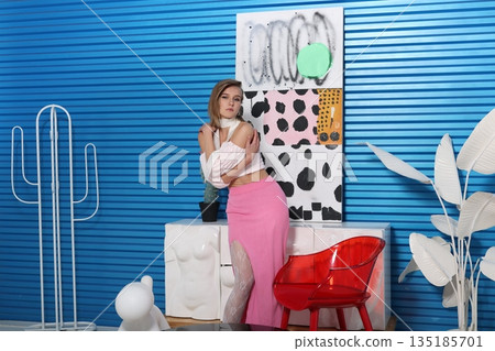 Closeup of poised individual with colorful artistic background 135185701