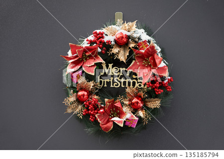 Seasonal wreath adorned with traditional holiday embellishments 135185794