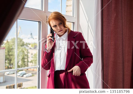 White woman with red hair delivering media statement outdoors 135185796