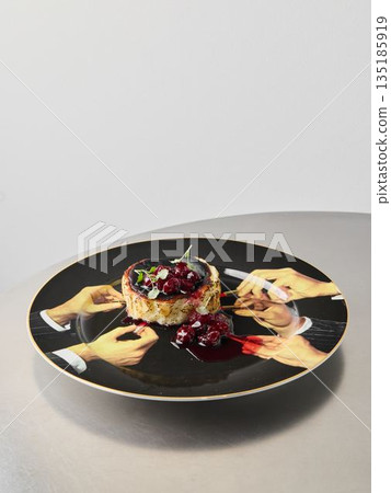 Overhead shot hands performing dessert ritual with dramatic sauce Overhead shot hands performing dessert ritual with dramatic sauce 135185919