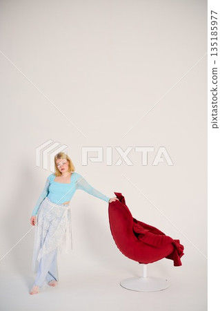 Casual lifestyle shot of woman in vibrant studio setting Casual lifestyle shot of woman in vibrant studio setting 135185977