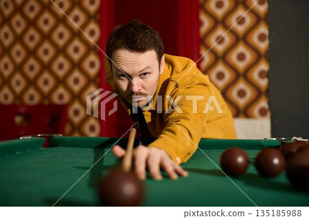 Caucasian player executing finishing shot in retro interior 135185988