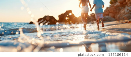 Couple running into ocean water at sunset 135186114