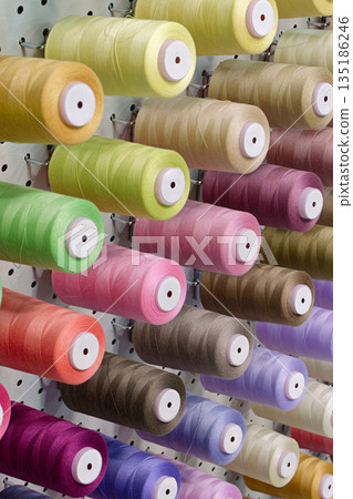 Many spools of thread of different colors 135186246