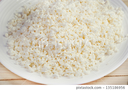 crumbly cottage cheese in a plate crumbly cottage cheese in a plate 135186956