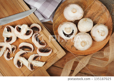 whole mushrooms on a wooden background 135187025