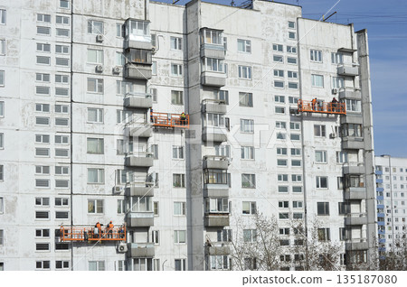workers in overhead elevators perform facade work in Moscow workers in overhead elevators perform facade work in Moscow 135187080