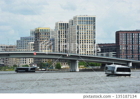 A water tram sails along the Moskva River along the Nagatinskaya embankment in Moscow A water tram sails along the Moskva River along the Nagatinskaya embankment in Moscow 135187134