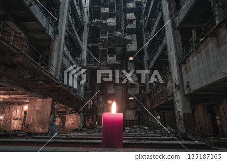 Candles provide light in an abandoned industrial building during the evening hours 135187165