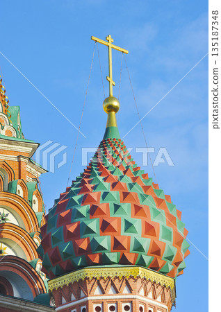 golden cross on the dome of St. Basil's Cathedral on Red Square in Moscow golden cross on the dome of St. Basil's Cathedral on Red Square in Moscow 135187348