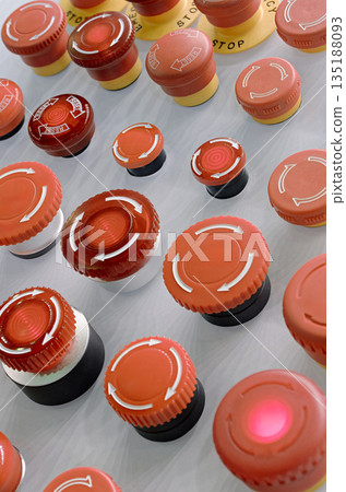 Multiple red emergency stop buttons on a grey metal panel Multiple red emergency stop buttons on a grey metal panel 135188093