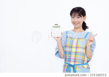 A housewife holding a calculator and making a peace sign A housewife holding a calculator and making a peace sign 135188553
