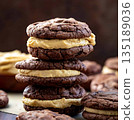 Chocolate Sandwich Cookies with Peanut Butter Filling and Brownie Texture 135189036
