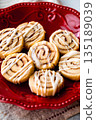 Cinnamon Roll Cookies with Icing on a Red Plate 135189039