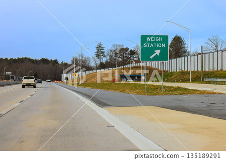 Drivers approach weigh station truck along US highway in rural setting Drivers approach weigh station truck along US highway in rural setting 135189291
