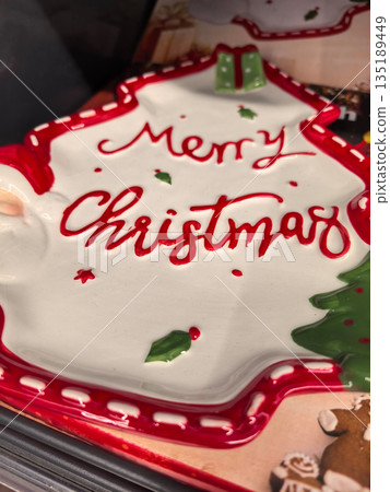 Festive ceramic plate showcasing a joyful Merry Christmas design Festive ceramic plate showcasing a joyful Merry Christmas design 135189449