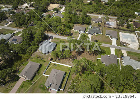 Aerial landscape view of suburban private houses between green palm trees in Florida quiet rural area Aerial landscape view of suburban private houses between green palm trees in Florida quiet rural area 135189643