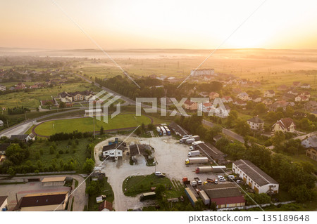 Aerial landscape of small town or village with rows of residential homes and green trees. Aerial landscape of small town or village with rows of residential homes and green trees. 135189648