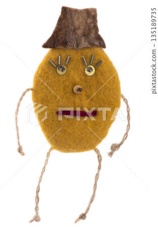 Suspension of felted wool in the form of a cheerful man on a white background Suspension of felted wool in the form of a cheerful man on a white background 135189735