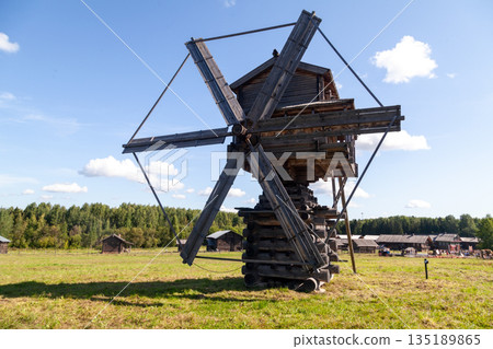 Historic Wooden Windmill with Large Blades under Blue Sky 135189865