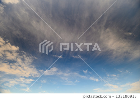 A Beautiful and Dramatic Sky Featuring Clouds Set Against a Clear Blue Background 135190913