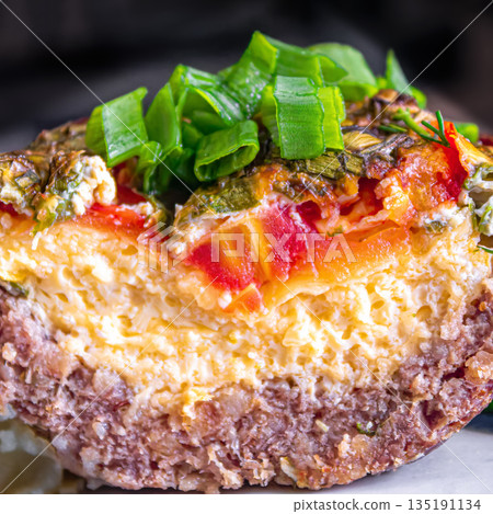 Fresh baked meat with cheese and tomatoes topped with chopped green onions Fresh baked meat with cheese and tomatoes topped with chopped green onions 135191134