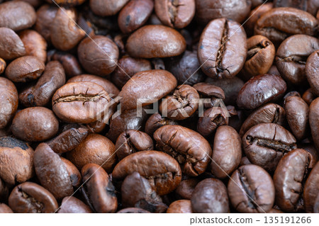 Macro of glossy coffee bean, Closeup image emphasizing glossy texture of coffee bean, Highly detailed macro photograph revealing smooth and shiny coffee bean surface Macro of glossy coffee bean, Closeup image emphasizing glossy texture of coffee bean, Highly detailed macro photograph revealing smooth and shiny coffee bean surface 135191266