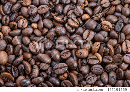 Earthtoned coffee beans emphasizing fair trade and cooperative farming, Detailed view of environmentally friendly roasted coffee beans highlighting origin and sustainable practices 135191269