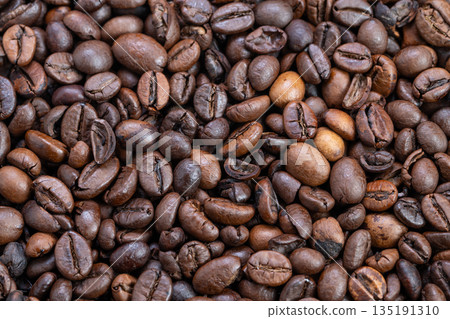 Vivid spotlight highlights coffee beans, Enhancing contrast with striking lighting emphasizes oilsheened espresso beans perfect for marketing and promotional visuals Vivid spotlight highlights coffee beans, Enhancing contrast with striking lighting emphasizes oilsheened espresso beans perfect for marketing and promotional visuals 135191310