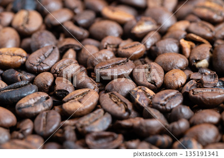 Warm and inviting setting showcasing beans and soothing background, Cozy environment featuring detailed coffee beans against softly blurred atmospheric backdrop 135191341