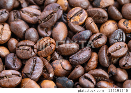 Premium coffee details, Detailed single origin coffee texture, Rich textured beans with tonal diversity, Single origin coffee beans showcasing fissures and color variation 135191346