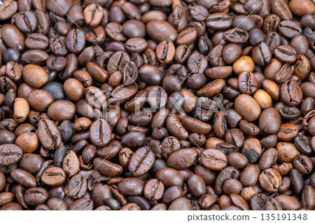 Vivid image showcasing scent and luster of freshly brewed coffee beans, An intricate perspective capturing fragrance and glossy appearance of newly roasted espresso beans 135191348
