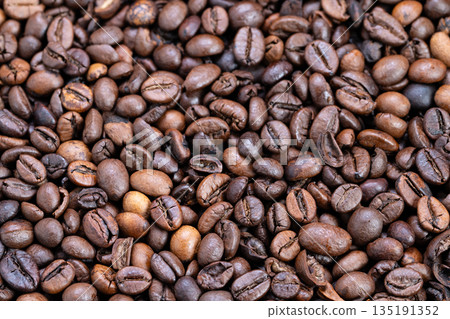 Coffee bean display, Artisan roasted Arabica coffee beans shown in detailed proximity image, Closeup shot illustrating rich texture of expertly roasted Arabica coffee beans Coffee bean display, Artisan roasted Arabica coffee beans shown in detailed proximity image, Closeup shot illustrating rich texture of expertly roasted Arabica coffee beans 135191352
