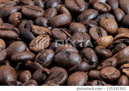 Artisan coffee beans displaying natural textures and earthy tones, Closeup image showcasing handcrafted coffee beans highlighting origin and sustainable farming practices 135191361