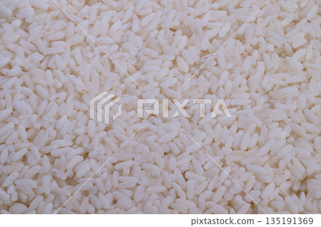Detailed view of glossy grains, Highresolution photograph capturing shiny rice grains in detail, Closeup shot highlighting smooth and reflective surface of steamed rice grains 135191369