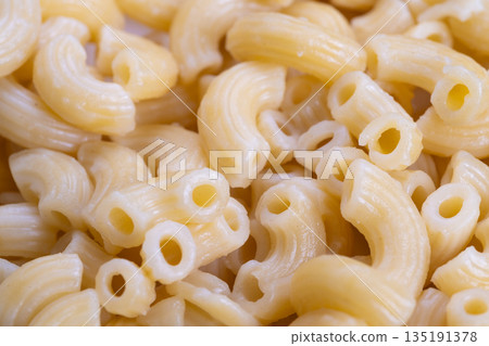 Tasty pasta presentation, Creamy cooked spirals in inviting and comforting tones, Delicious creamy elbow macaroni carefully presented in warmly inviting bowl environment 135191378