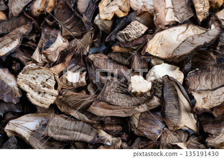 Dehydrated mushroom slices, Closeup of artisan dried mushrooms for culinary presentation, Highquality image showcasing dried mushrooms with gourmet culinary and styling appeal 135191430