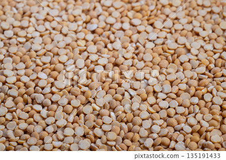 Yellow split peas close up creating seamless texture background, high detail macro shot, soft lighting, warm color palette for food styling and packaging mockups Yellow split peas close up creating seamless texture background, high detail macro shot, soft lighting, warm color palette for food styling and packaging mockups 135191433