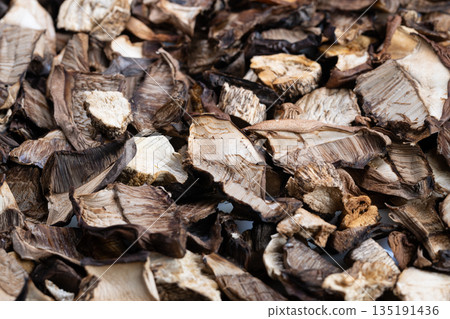 Dried mushrooms stored, Diverse selection of preserved dried mushrooms for cooking, Collection of dried mushrooms in various cuts suitable for storage and culinary use 135191436