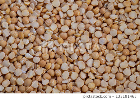 Vivid macro image showcasing intricate split peas surface details, Highresolution photograph highlighting fine textures and warm tones of split yellow peas for culinary use Vivid macro image showcasing intricate split peas surface details, Highresolution photograph highlighting fine textures and warm tones of split yellow peas for culinary use 135191465