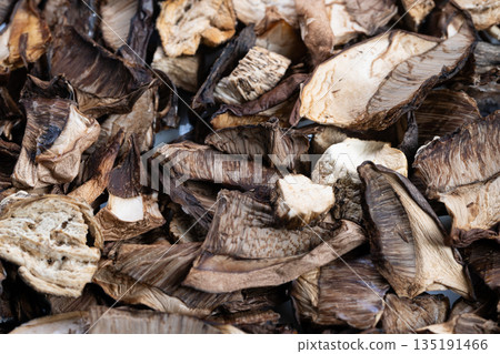 Autumn dried mushrooms harvest stockpile for pantry storage, assorted sliced caps and stems form warm seasonal palette, evokes cozy cooking, preservation and home food traditions Autumn dried mushrooms harvest stockpile for pantry storage, assorted sliced caps and stems form warm seasonal palette, evokes cozy cooking, preservation and home food traditions 135191466