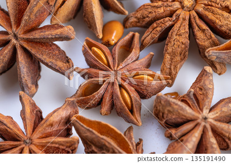 Highresolution macro shot emphasizing rustic kitchen spices and textures, Captivating closeup capturing intricate details of star anise pods and seeds in natural warm lighting Highresolution macro shot emphasizing rustic kitchen spices and textures, Captivating closeup capturing intricate details of star anise pods and seeds in natural warm lighting 135191490
