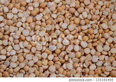 Highdetail image showcasing golden split peas texture and arrangement, Professional industrial photograph of uniform yellow peas prepared for packaging and processing 135191493