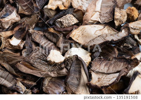 Sorting dried fungi for storage, Dehydrated mushrooms sorted on tray for preservation, Tray filled with dried mushrooms arranged for stockpile and preservation purposes 135191508