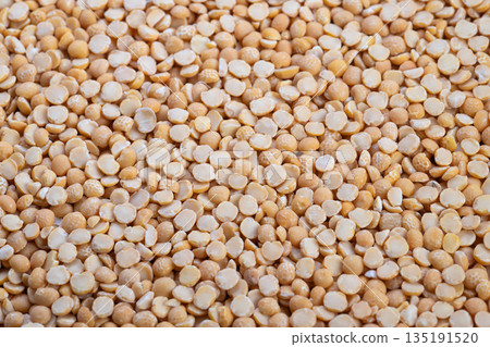 Closeup yellow split peas texture, dense culinary surface ready for photography and ingredient styling, neutral lighting highlighting natural matte sheen and curved halves Closeup yellow split peas texture, dense culinary surface ready for photography and ingredient styling, neutral lighting highlighting natural matte sheen and curved halves 135191520