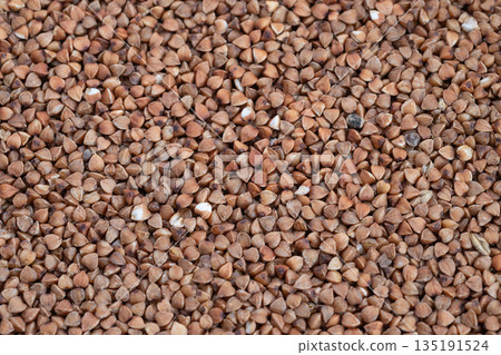 Earthy buckwheat grain closeup, Texture of raw buckwheat seeds detailed, Highresolution image highlighting earthy buckwheat groats for branding and product display Earthy buckwheat grain closeup, Texture of raw buckwheat seeds detailed, Highresolution image highlighting earthy buckwheat groats for branding and product display 135191524
